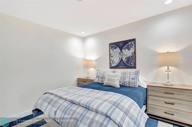 1985 Sailfish Place Pompano Beach, FL 33062 - Photo 39 of 47 a bedroom with a large bed and a lamp on dresser