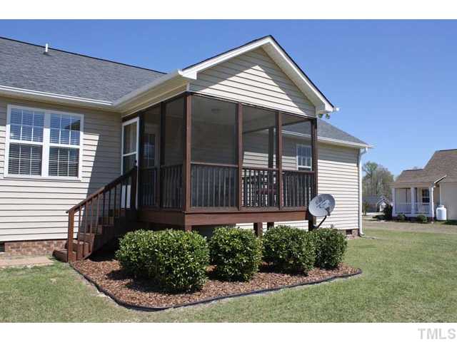 462 Axum Road Willow Spring, NC 27592 - Photo 14 of 18 a view of a house with a garden and deck