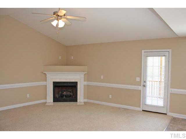 462 Axum Road Willow Spring, NC 27592 - Photo 4 of 18 an empty room with windows and fireplace