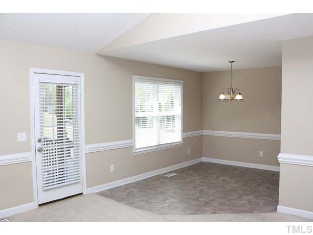 462 Axum Road Willow Spring, NC 27592 - Photo 5 of 18 a view of wooden floor and windows in a room