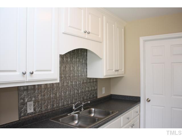 462 Axum Road Willow Spring, NC 27592 - Photo 6 of 18 a kitchen with a sink and cabinets