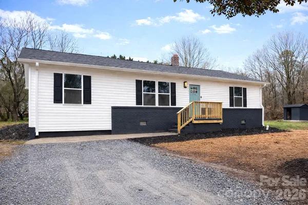 a view of a house with a yard and garage