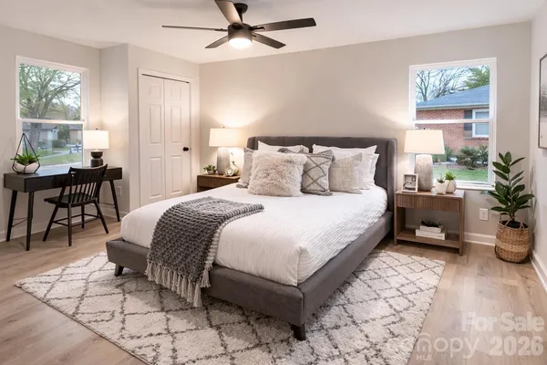 a bedroom with a bed and a table in it with window