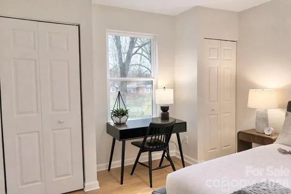 a bedroom with a bed and a table