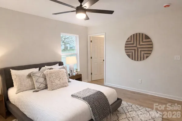 a bedroom with a bed and a chandelier