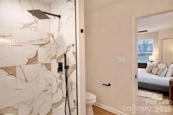 a spacious bathroom with a shower and toilet