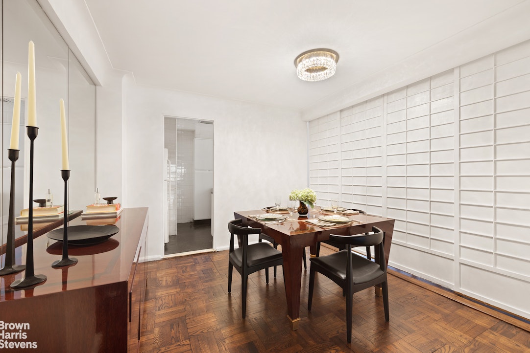 880 5th Avenue, Unit 9K Manhattan, NY 10021 - Photo 4 of 7 a view of a dining room with furniture and window