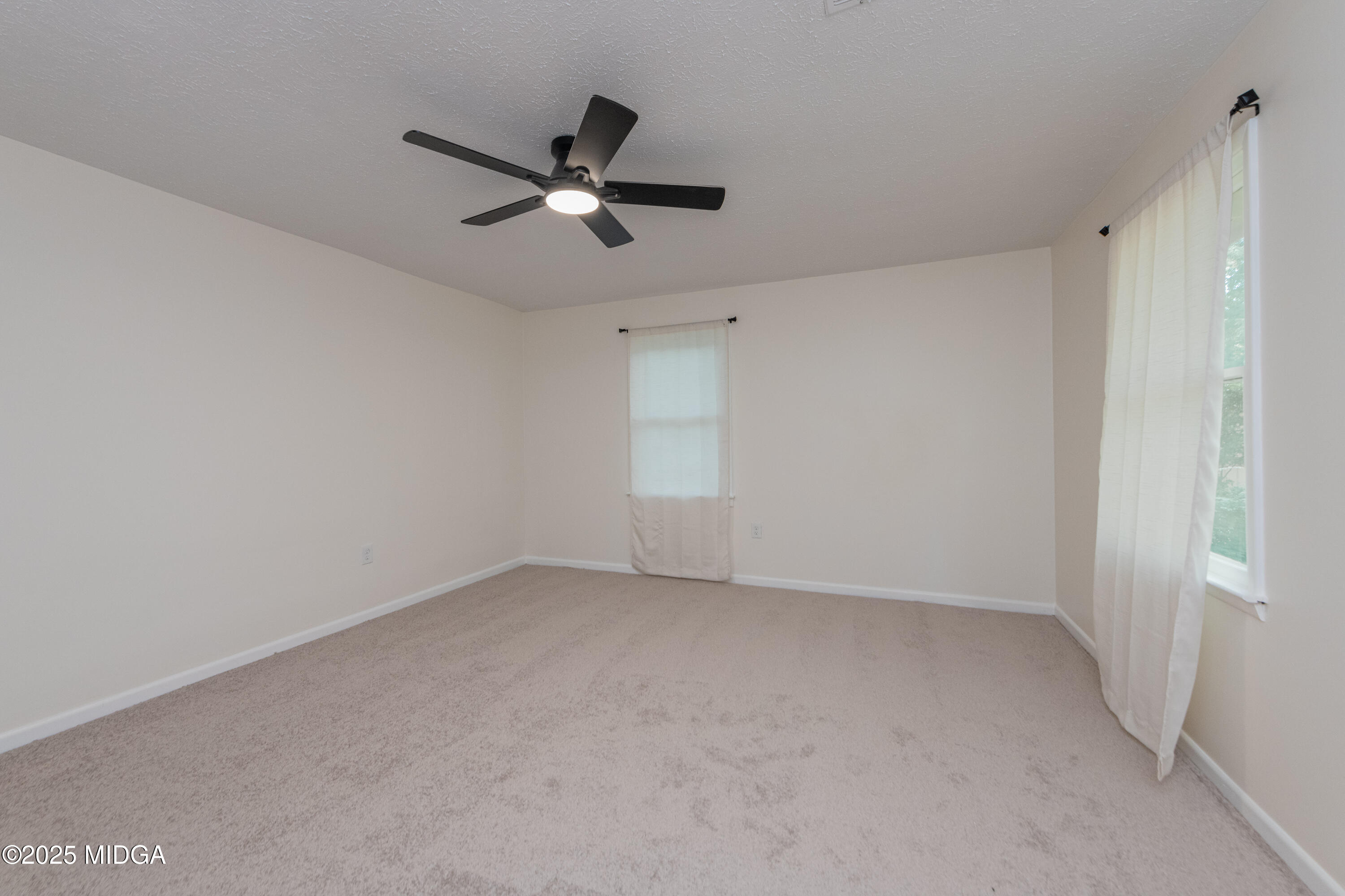 139 Old Oak Road Byron, GA 31008 - Photo 4 of 59 a view of a big room with a ceiling fan and windows
