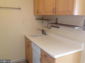 522 21st Street Northwest, Unit 307 Washington, DC 20006 - Photo 8 of 8 a kitchen with a sink and cabinets