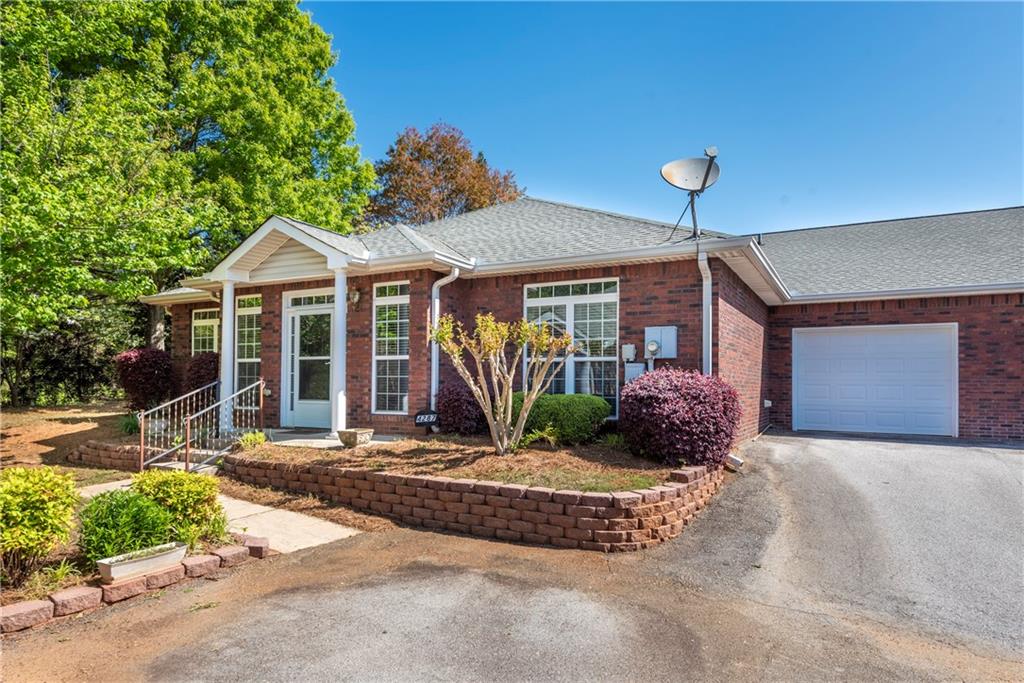 a front view of a house with garden