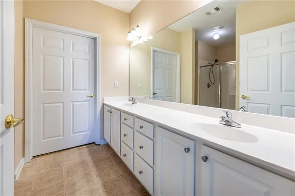 a spacious bathroom with a double vanity sink mirror and