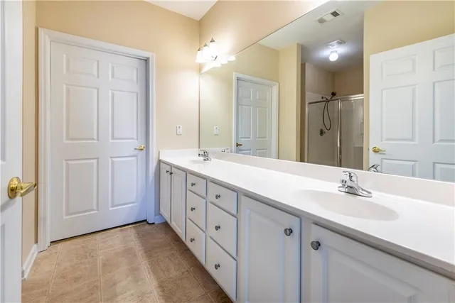 a spacious bathroom with a double vanity sink mirror and
