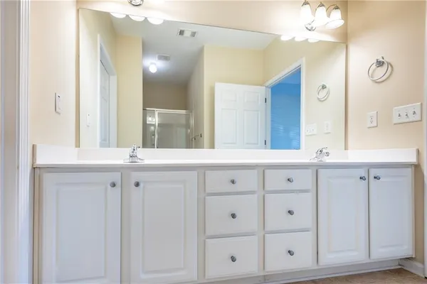 a bathroom with a double vanity sink and mirror
