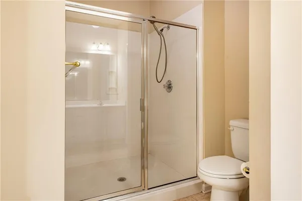 a bathroom with a glass shower door