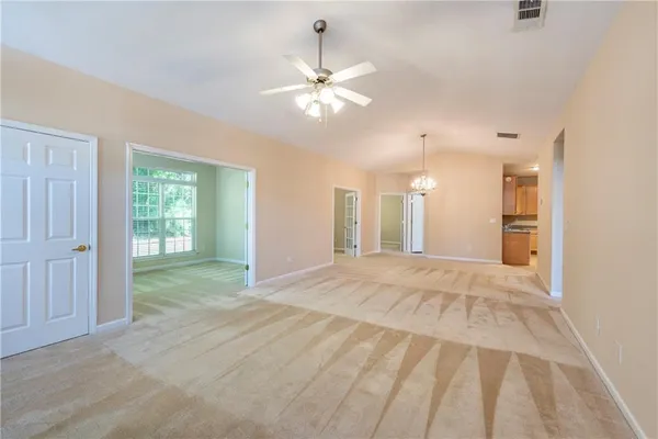 a view of a livingroom with a ceiling fan and window