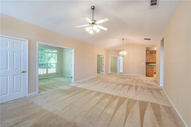 a view of a livingroom with a ceiling fan and window