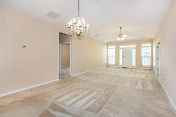 a view of an empty room with a chandelier