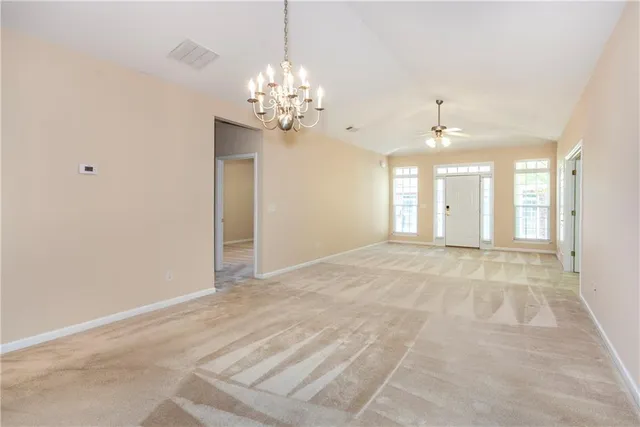 a view of an empty room with a chandelier