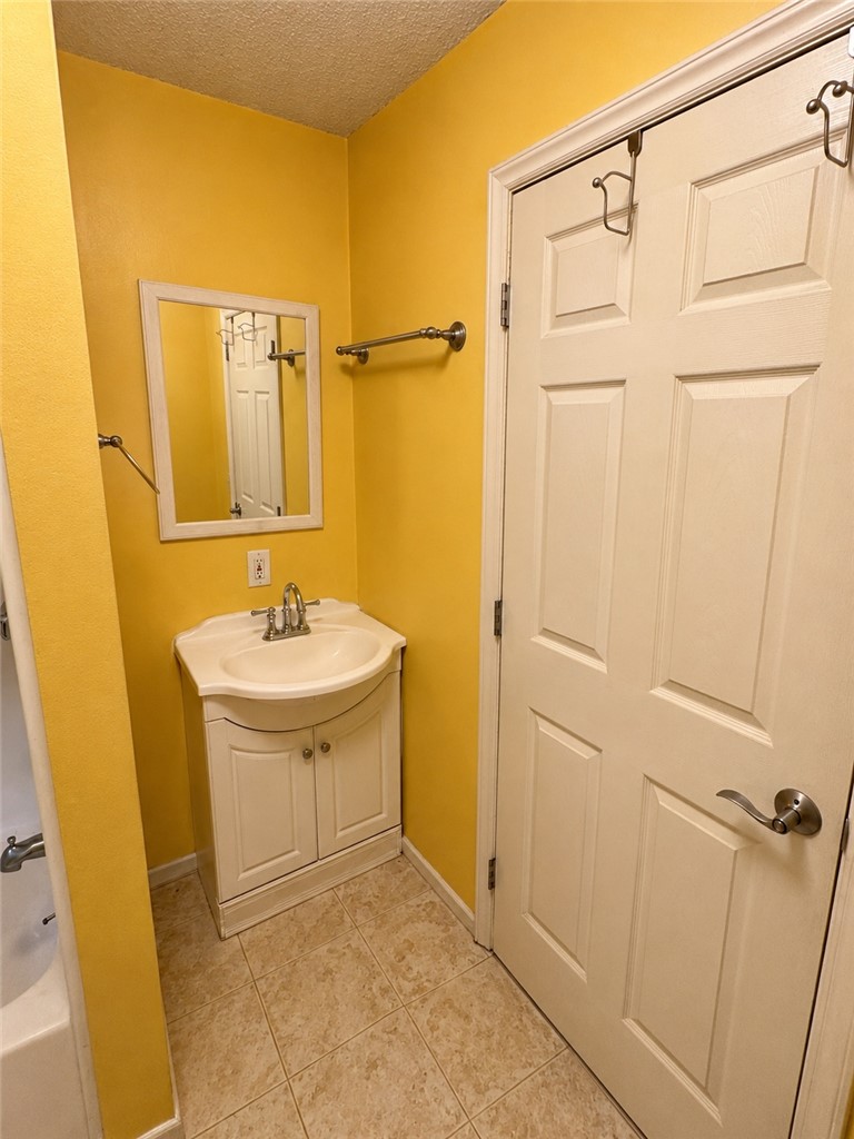 138 Cloverdale Road Seneca, SC 29678 - Photo 22 of 27 A cheerful bathroom featuring a compact vanity and practical tile flooring.