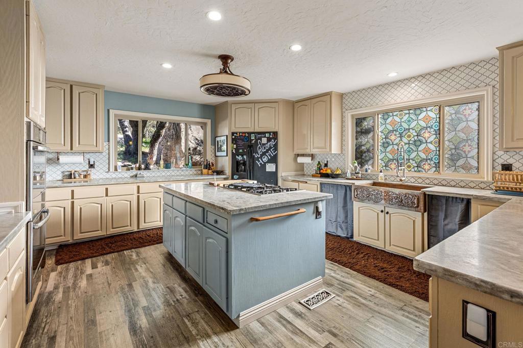 8411 Foothill Boulevard Pine Valley, CA 91962 - Photo 9 of 46 a kitchen with a sink stove cabinets and wooden floor