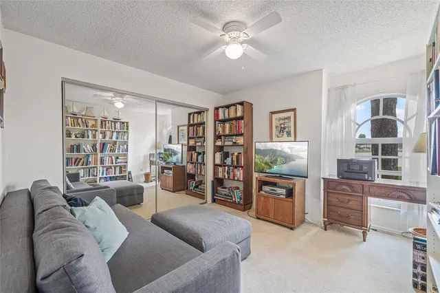 a spacious bedroom with a bed and a chandelier