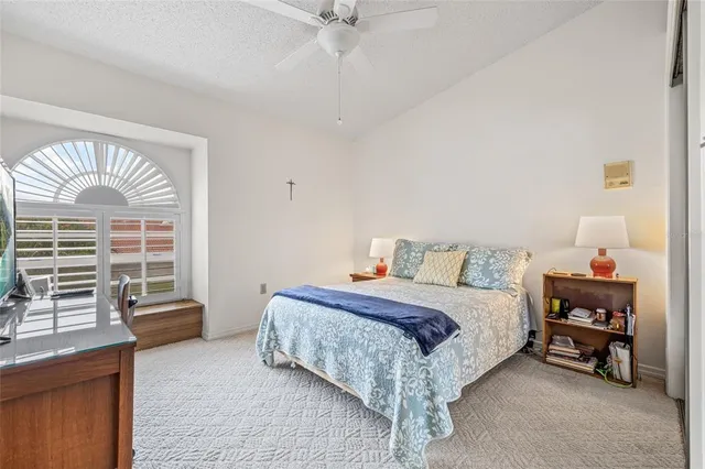 wooden floor in an empty room with a ceiling fan
