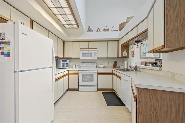 a kitchen with refrigerator and cabinets