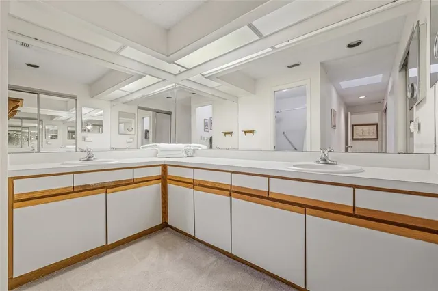 a bathroom with a granite countertop sink mirror vanity and toilet