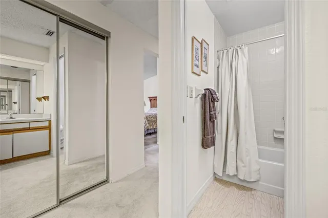 a bathroom with a toilet sink vanity and mirror