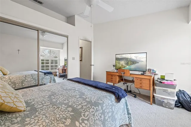 a view of a brick house with a big yard and large trees