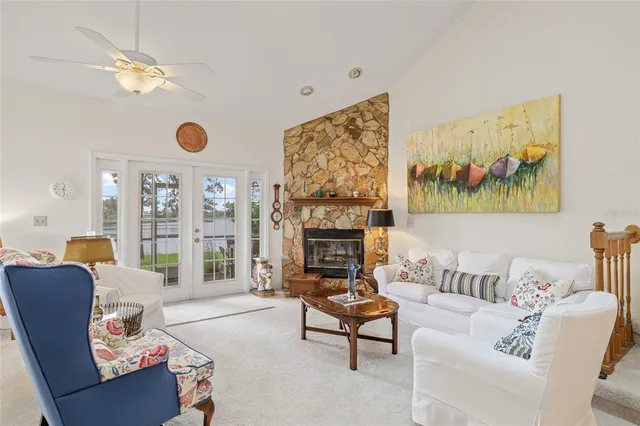a living room with furniture a fireplace and a large window
