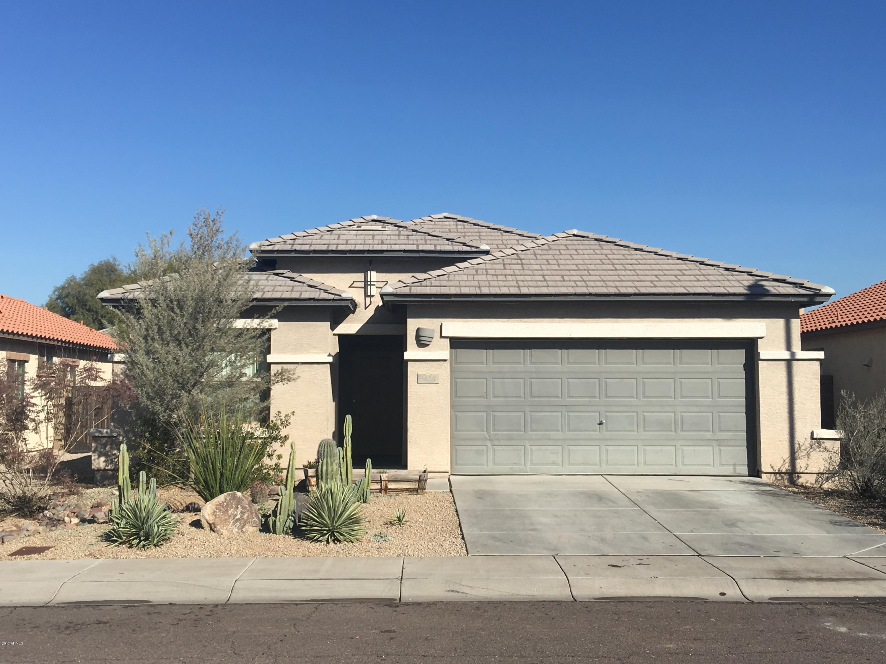 9128 West Berkeley Road Phoenix, AZ 85037 - Photo 1 of 17 a front view of a house with a yard and garage