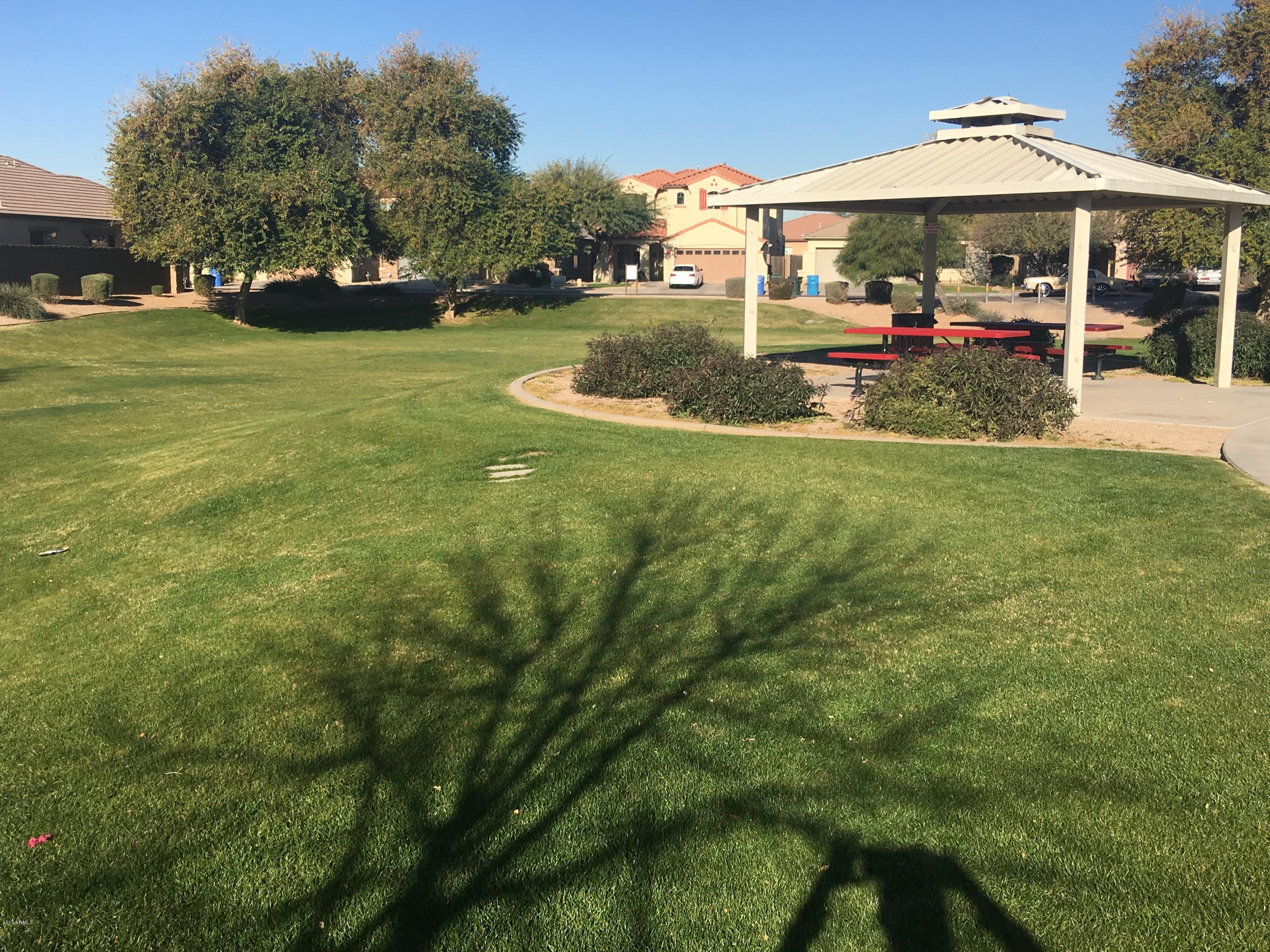 9128 West Berkeley Road Phoenix, AZ 85037 - Photo 14 of 17 a view of a house with a yard