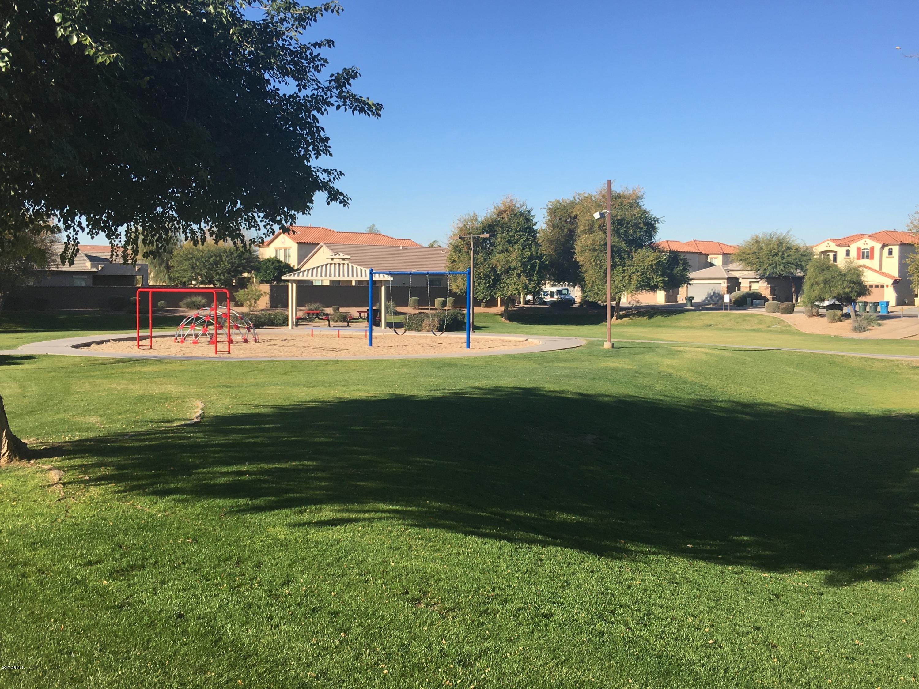 9128 West Berkeley Road Phoenix, AZ 85037 - Photo 15 of 17 a front view of a house with a yard table and chairs