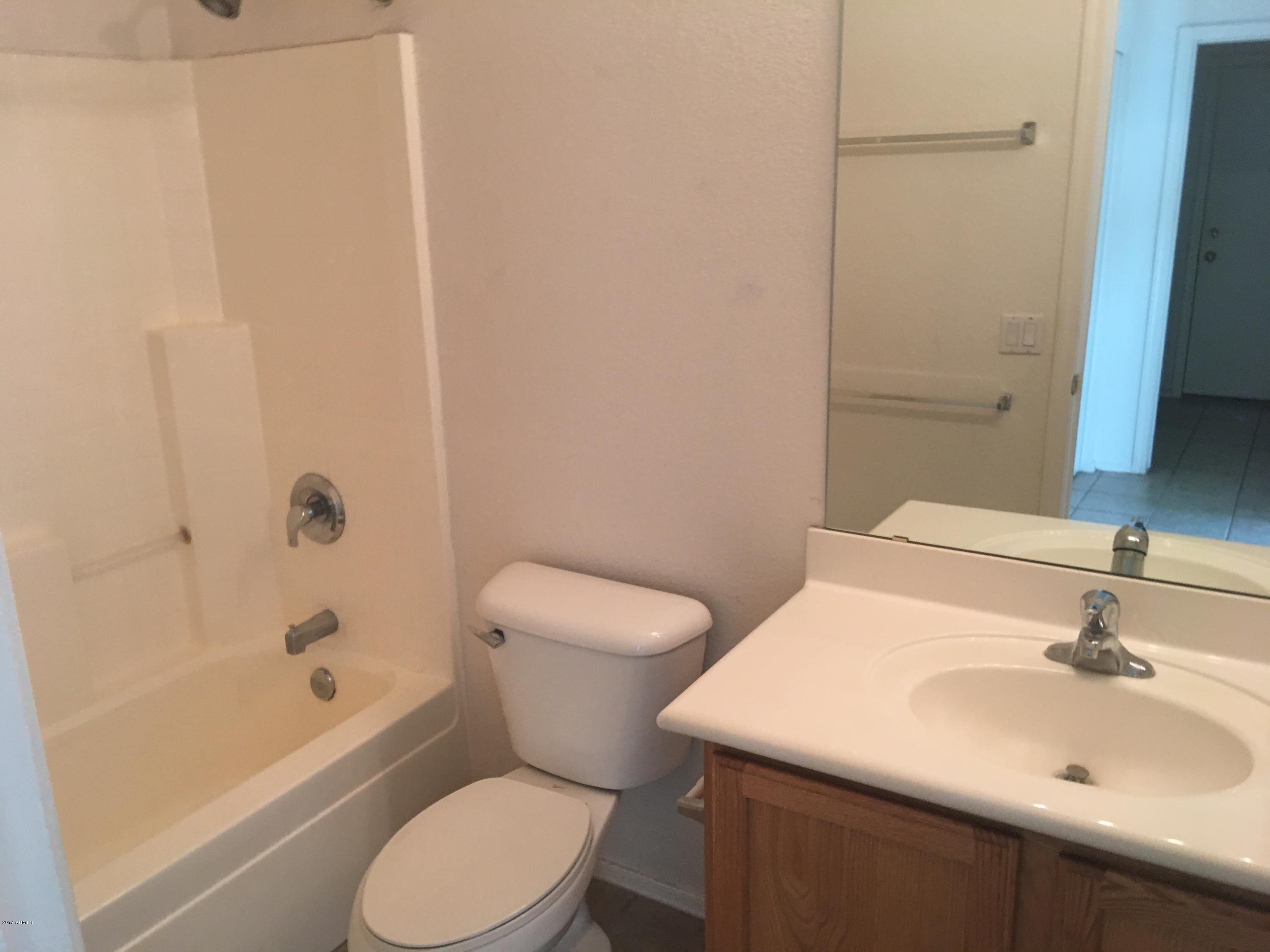9128 West Berkeley Road Phoenix, AZ 85037 - Photo 7 of 17 a bathroom with a sink a toilet and shower
