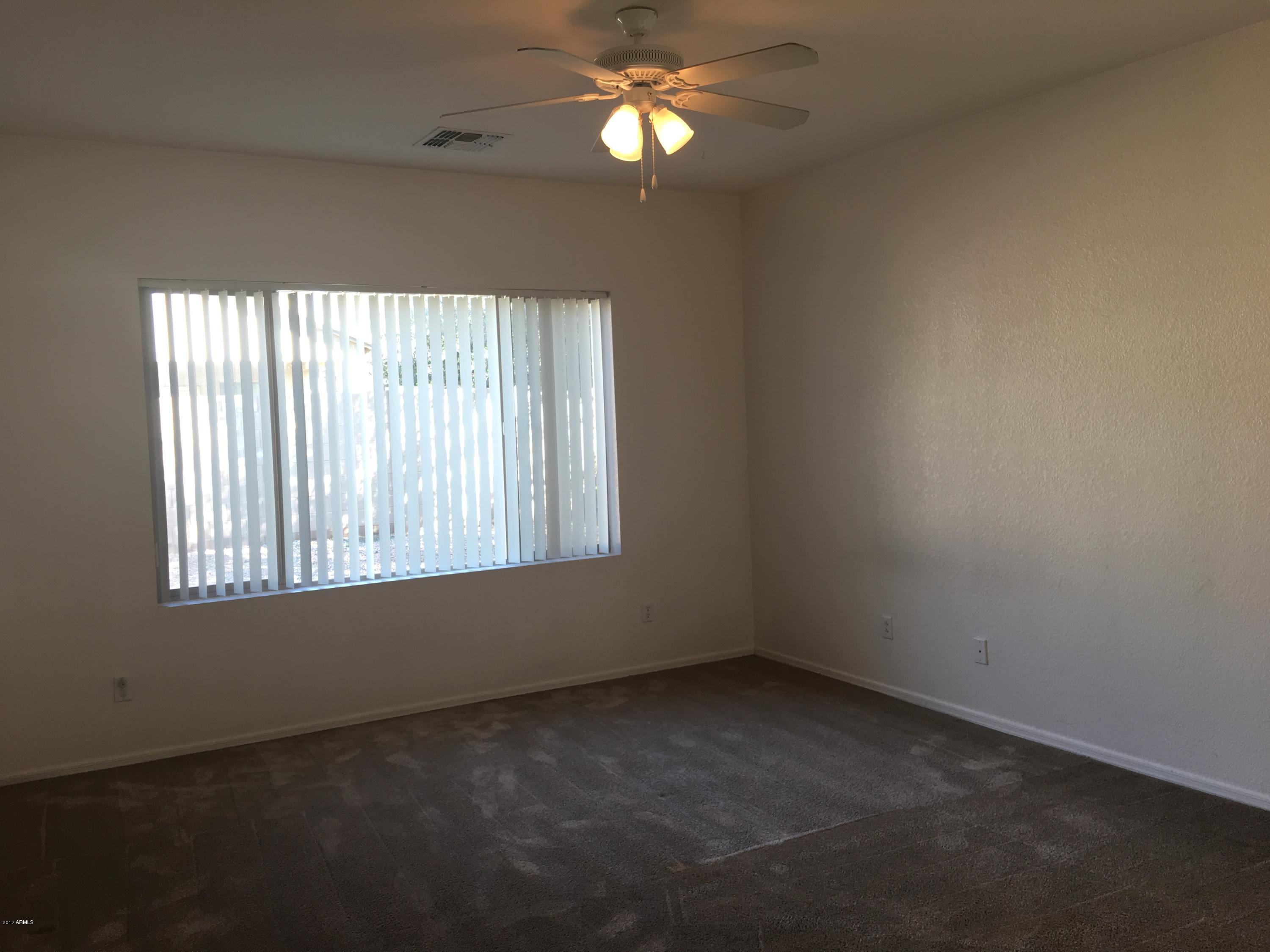 9128 West Berkeley Road Phoenix, AZ 85037 - Photo 10 of 17 an empty room with a window