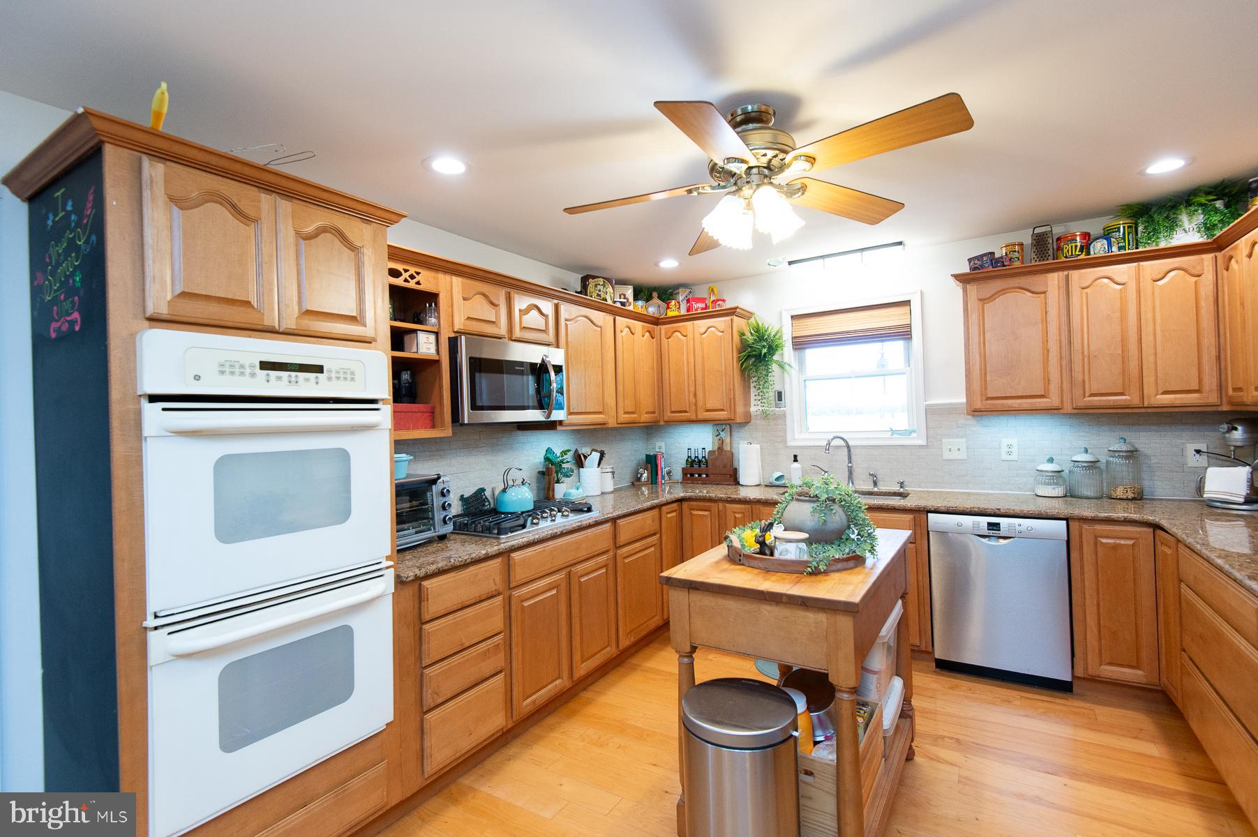 12136 Holly Road Ridgely, MD 21660 - Photo 21 of 136 a kitchen with stainless steel appliances granite countertop a stove refrigerator sink and cabinets