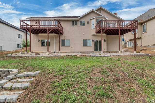 2154 Wasatch Boulevard Sandy, UT 84092 - Photo 32 of 55 Rear view of property with a patio area, a deck, stucco siding, and a lawn