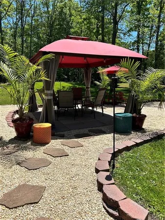 a view of a patio with table and chairs potted plants