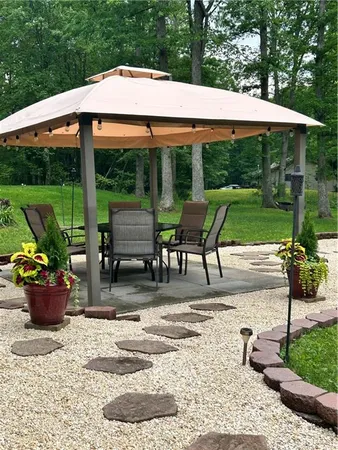 a view of a patio with a table chairs and a yard
