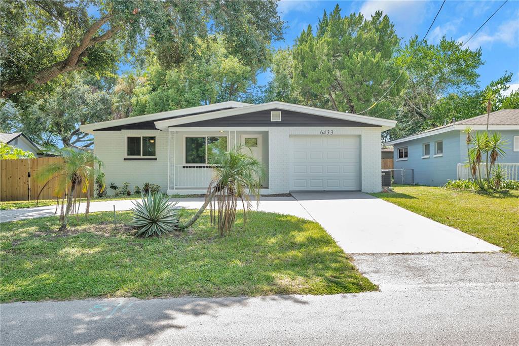 6433 River Road New Port Richey, FL 34652 - Photo 1 of 1 a front view of house with yard and green space