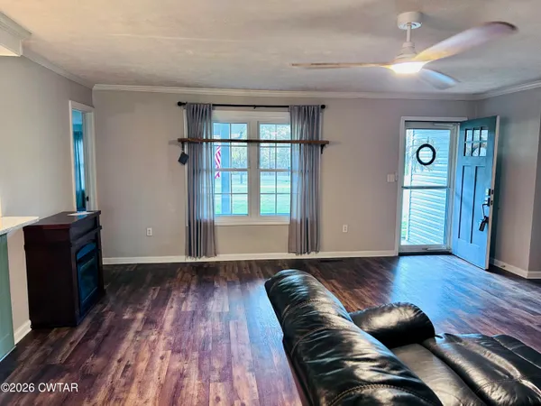 a living room with furniture and wooden floor