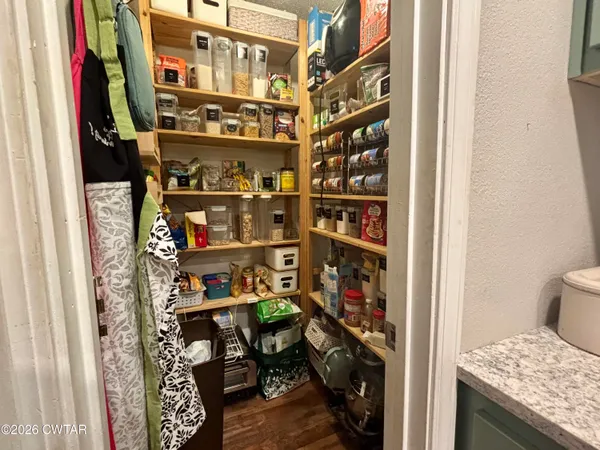 a view of a big room with windows and hardwood floor