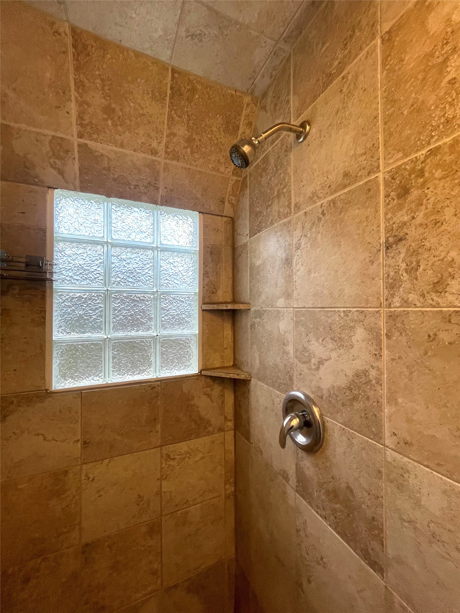 1127 Walling Street, Unit 2 Houston, TX 77009 - Photo 13 of 15 Elegant shower with warm-toned tile and a stylish glass block window for natural light.