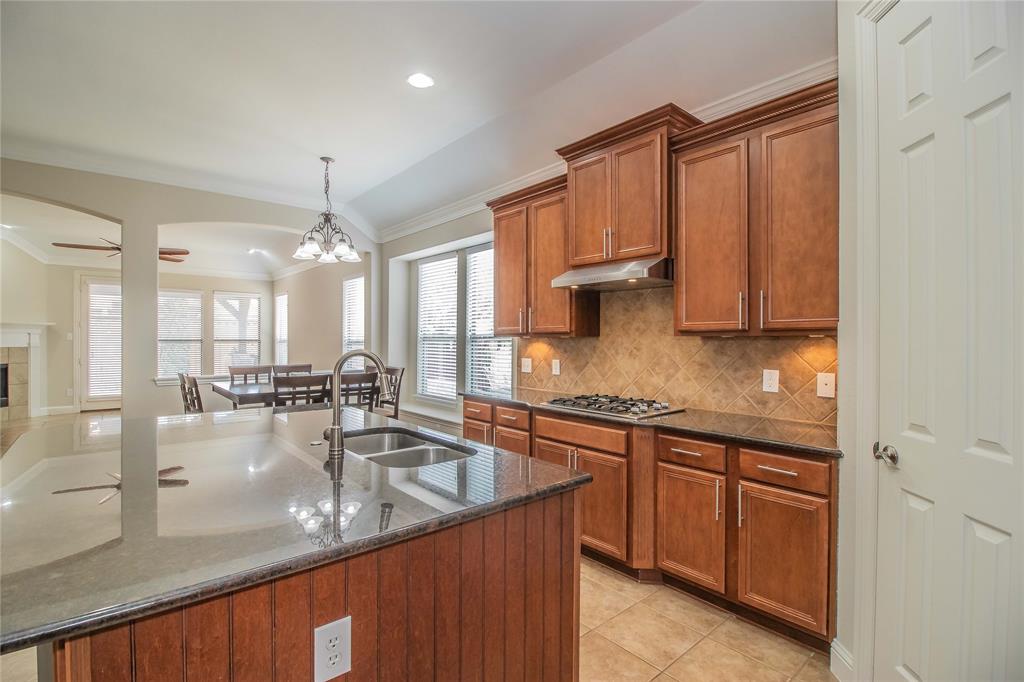 4647 Phillip Drive Plano, TX 75024 - Photo 11 of 38 a kitchen with stainless steel appliances granite countertop a sink stove and cabinets