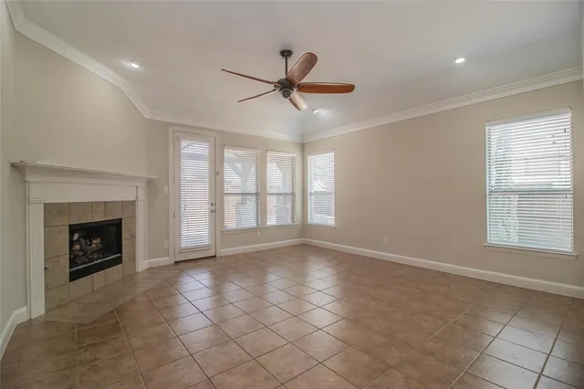 a view of an empty room with a fireplace and a window