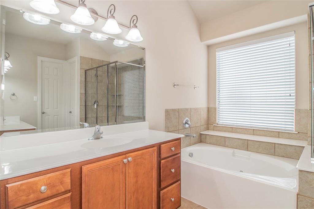 4647 Phillip Drive Plano, TX 75024 - Photo 21 of 38 a bathroom with a tub sink and mirror