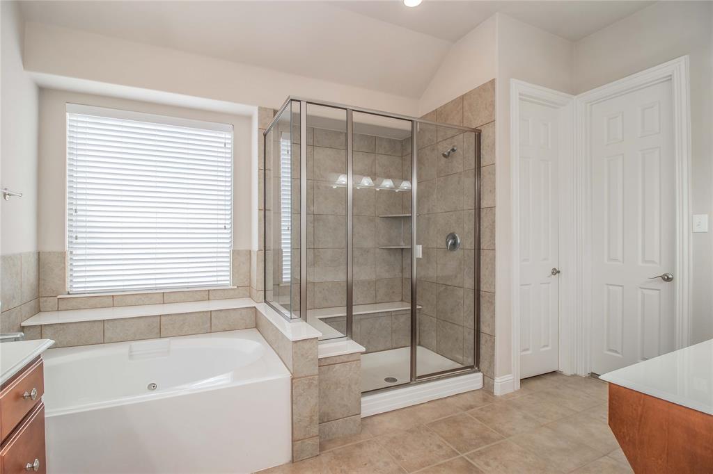 4647 Phillip Drive Plano, TX 75024 - Photo 22 of 38 a bathroom with a bathtub and shower