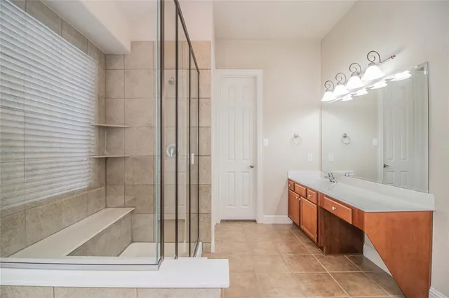 a bathroom with a granite countertop sink a mirror and a bathtub