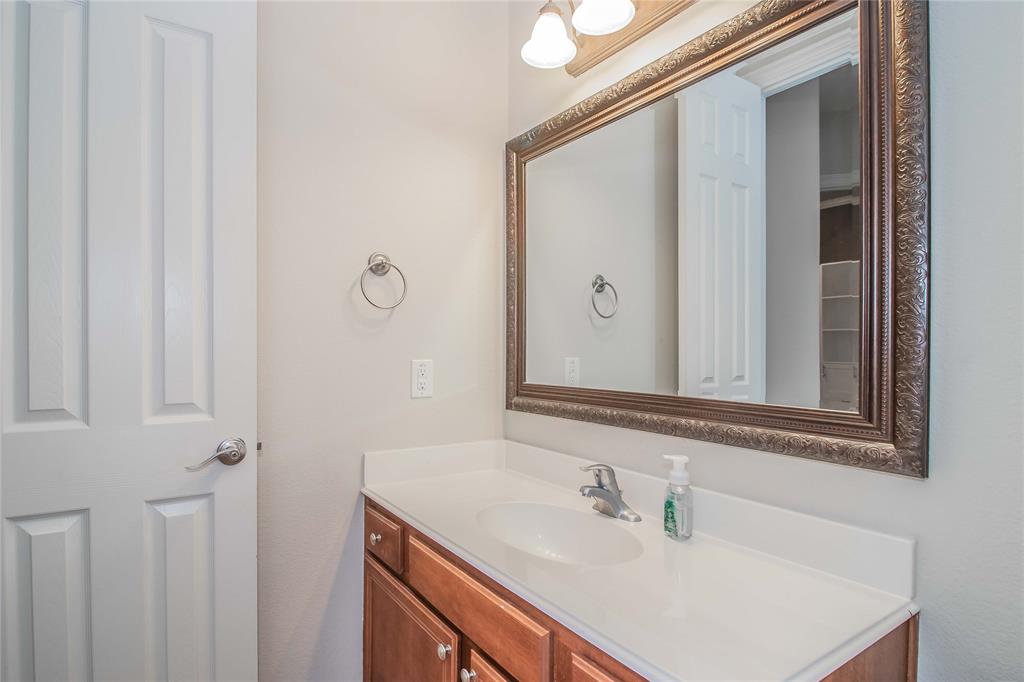 4647 Phillip Drive Plano, TX 75024 - Photo 25 of 38 a bathroom with a sink and a mirror